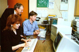 Godfrey working on the telecommunications research Project Cue, with Writing co-op students Rhonda Roy & Michael Quinlan. Project Cue promoted electronic communication using the CoSy conferencing system. (OVPR)