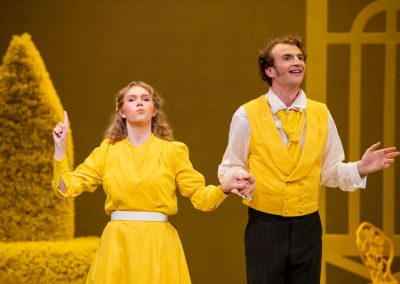 2 actors in yellow costumes in The Importance of being Earnest