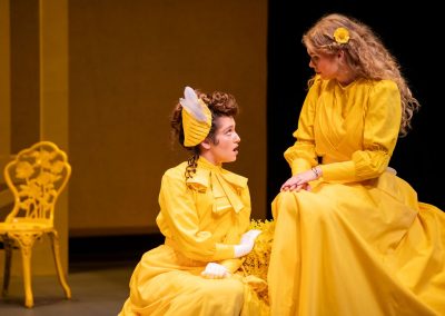 2 actors in yellow costumes in the importance of being earnest